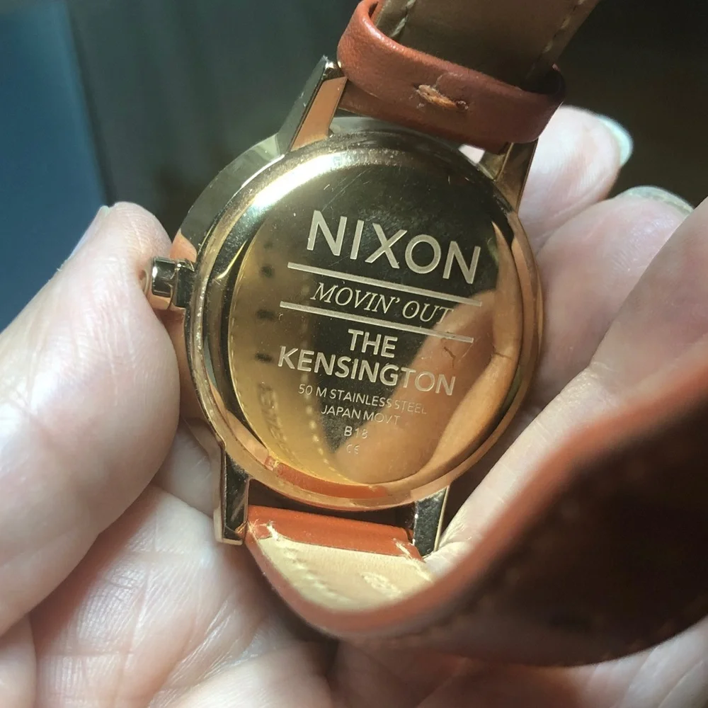 Nixon watch with box instructions and extra black strap.  Woman’s watch.